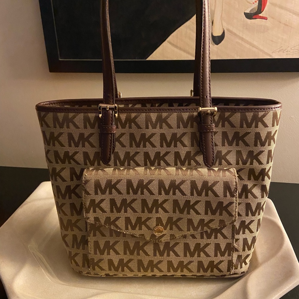 Michael Kors monogram tote style bag with leather handles in brown and tan